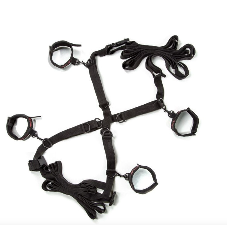 Scandal Over the Bed Cross restraint system laid out flat with adjustable straps and cuffs