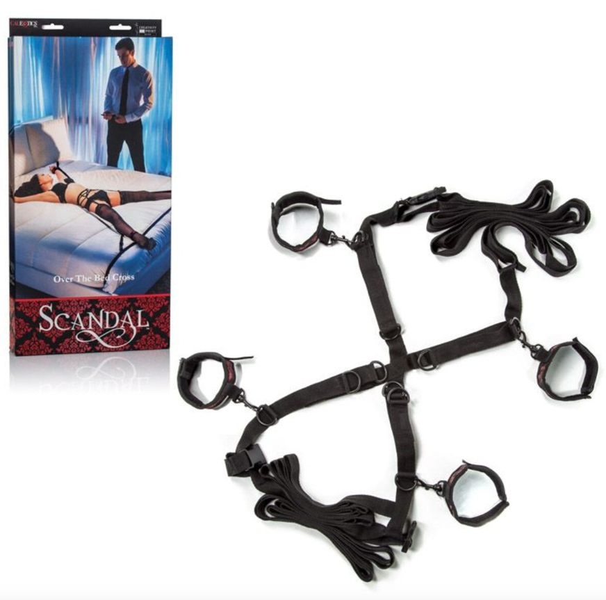 Scandal Over the Bed Cross packaging with model illustration showing restraint system in use
