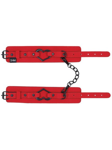 Sex and Mischief Amor Handcuffs laid flat showing adjustable buckle straps and black heart detail
