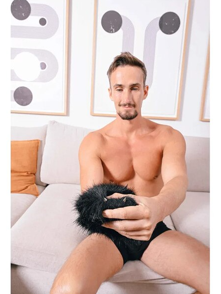 Male model using Spiked Sensory Mitt during play
