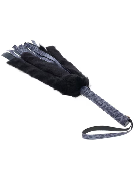 Angled view of Sex and Mischief Cougar Faux Fur Flogger in purple showing dual textures